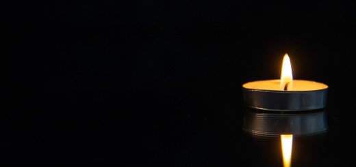 front-view-little-burning-candle-black